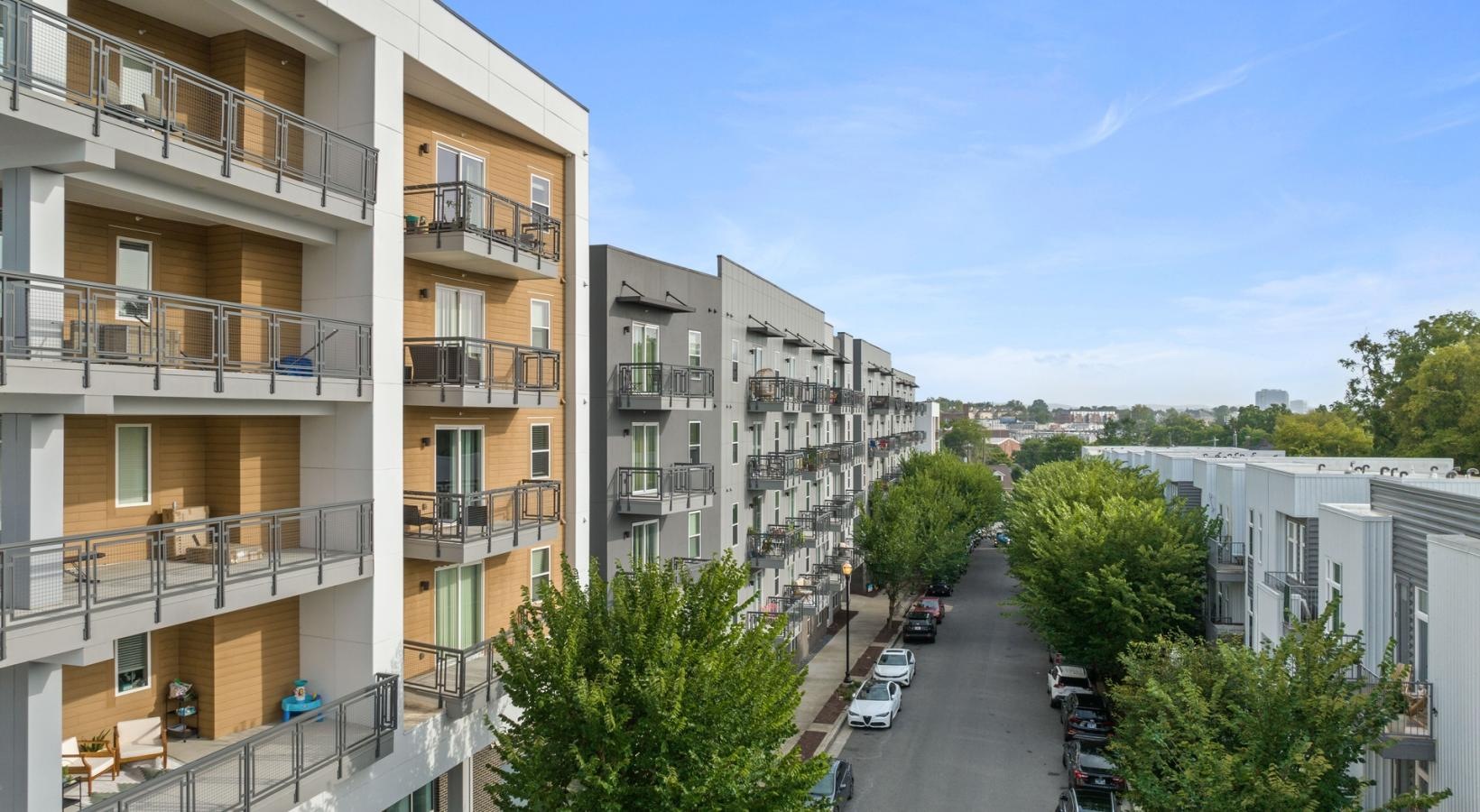 Generous balconies a street with cars and buildings