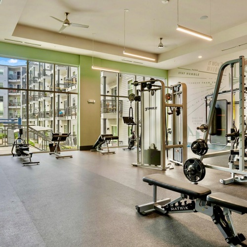 a room with exercise equipment and a whiteboard