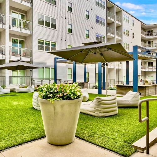 a courtyard with a couple of umbrellas and a couple of plants