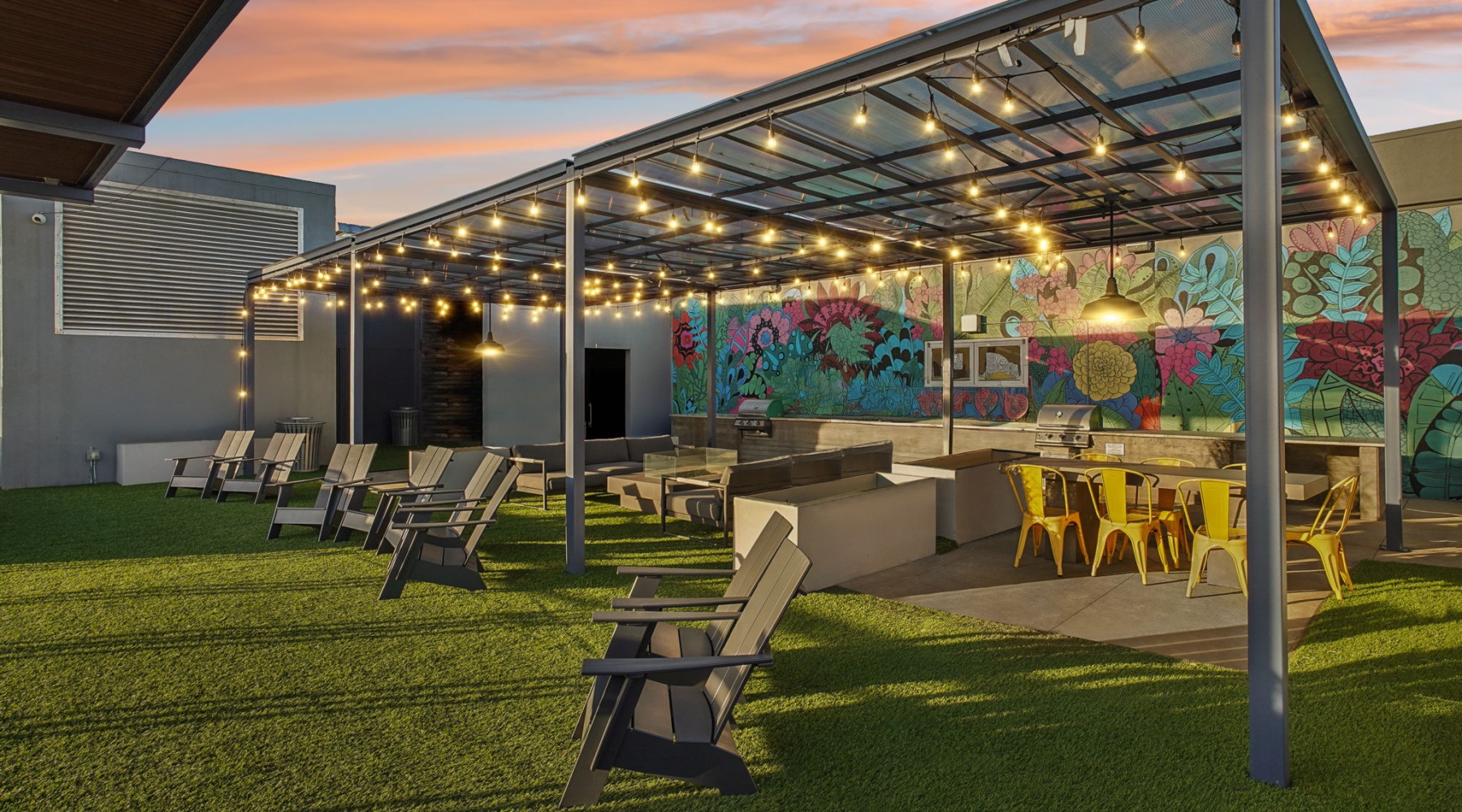 Outdoor sky deck lounge with mural and cafe lights