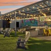 Outdoor sky deck lounge with mural and cafe lights