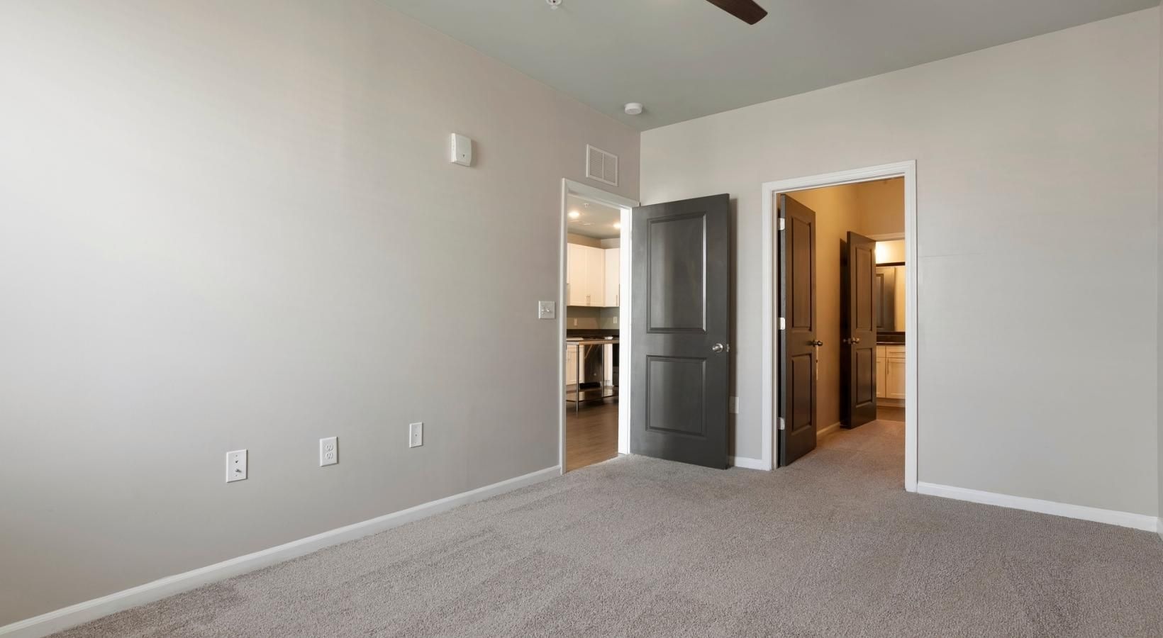 Find your perfect fit at The Cleo a room with a carpet and a ceiling fan