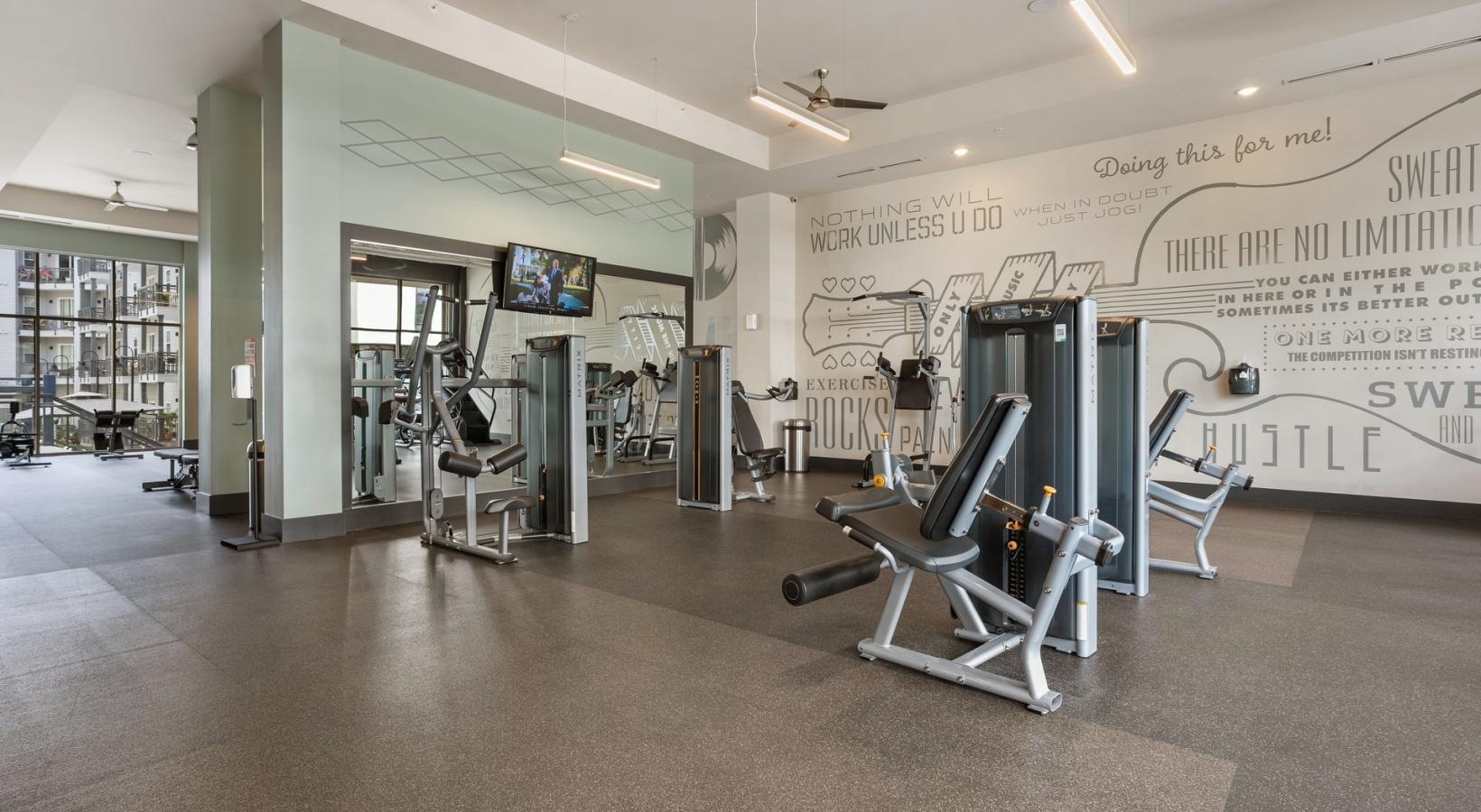 Get your workout on a room with exercise equipment and a whiteboard
