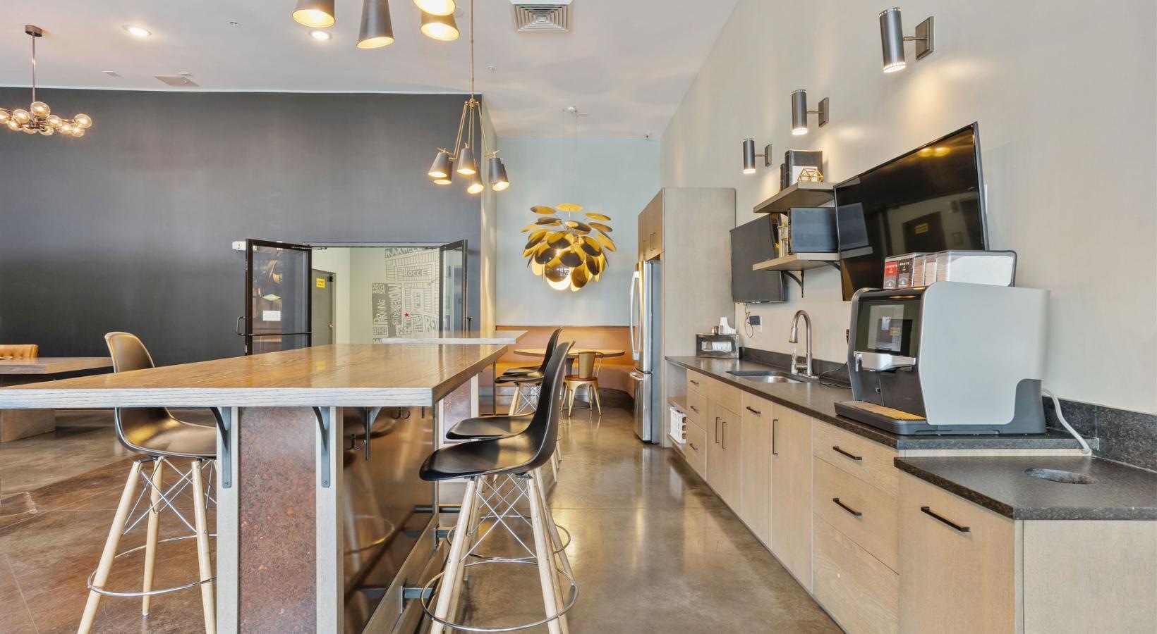 Find your perfect fit at The Cleo a kitchen with a table and chairs