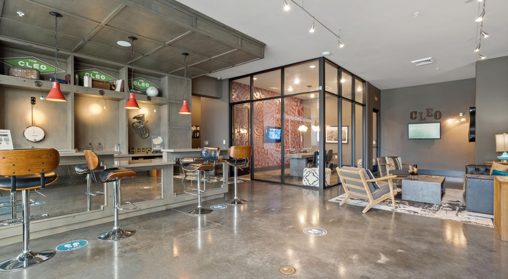 Settle into comfort at The Cleo a room with tables and chairs